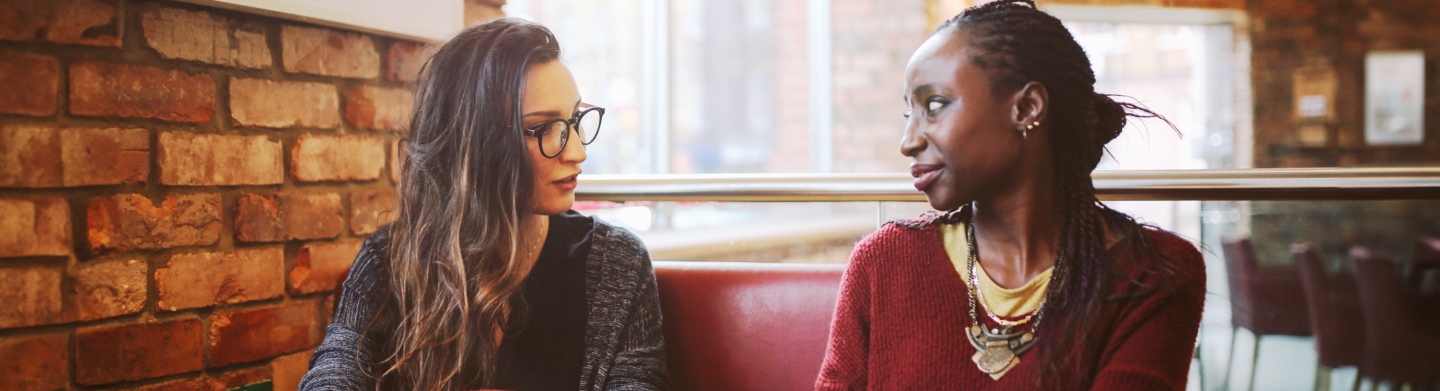 Two women talking at a cafe